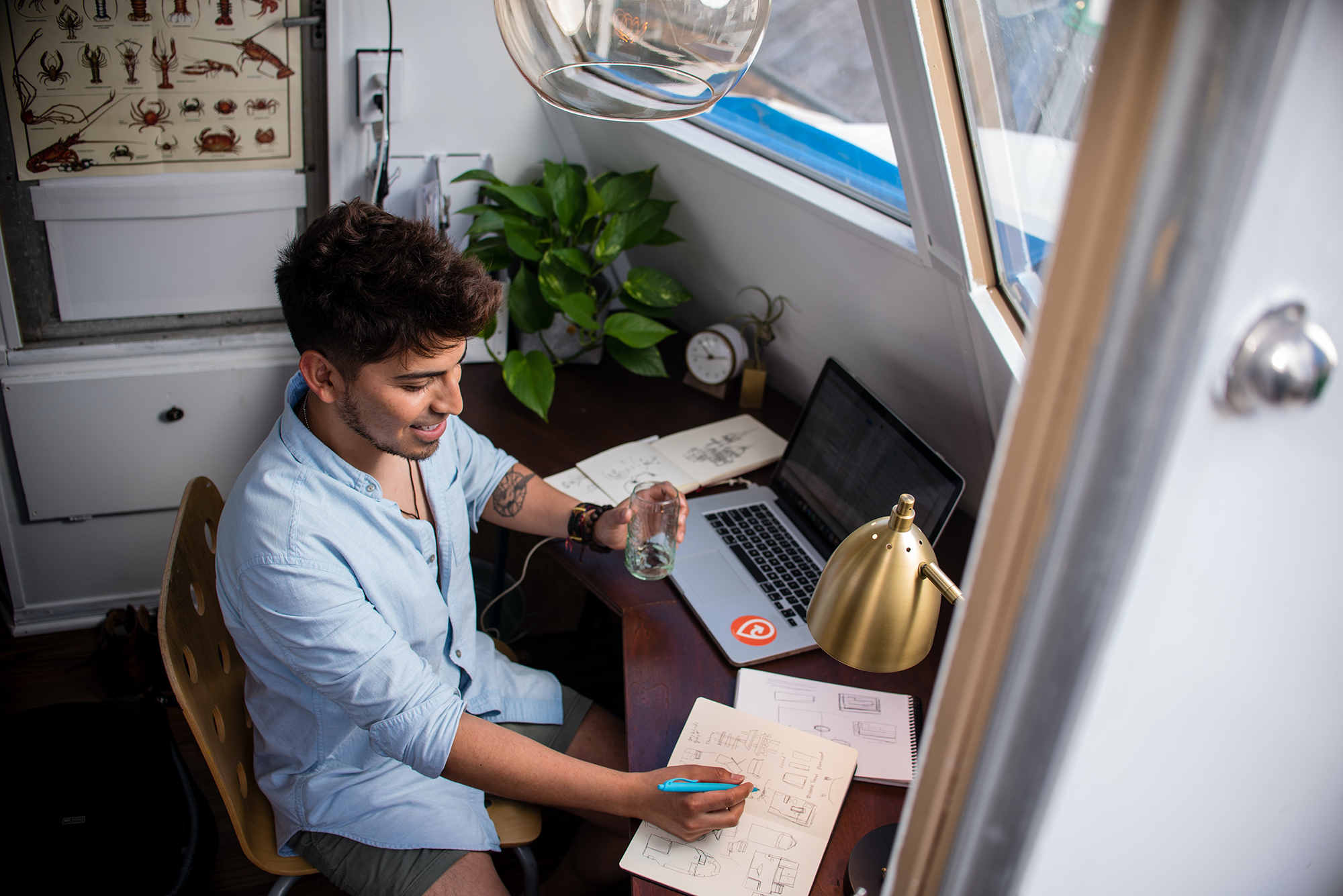 Young production expert working at desk with laptop showing creative staffing services