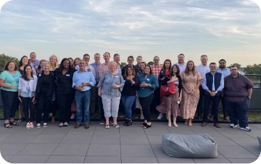 Onward Search staffing and recruiting team posing for group photo outside at sunset