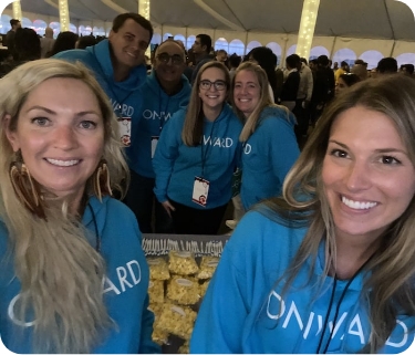 Group of creative recruiters wearing blue Onward Search at diversity, equity, and inclusion conference