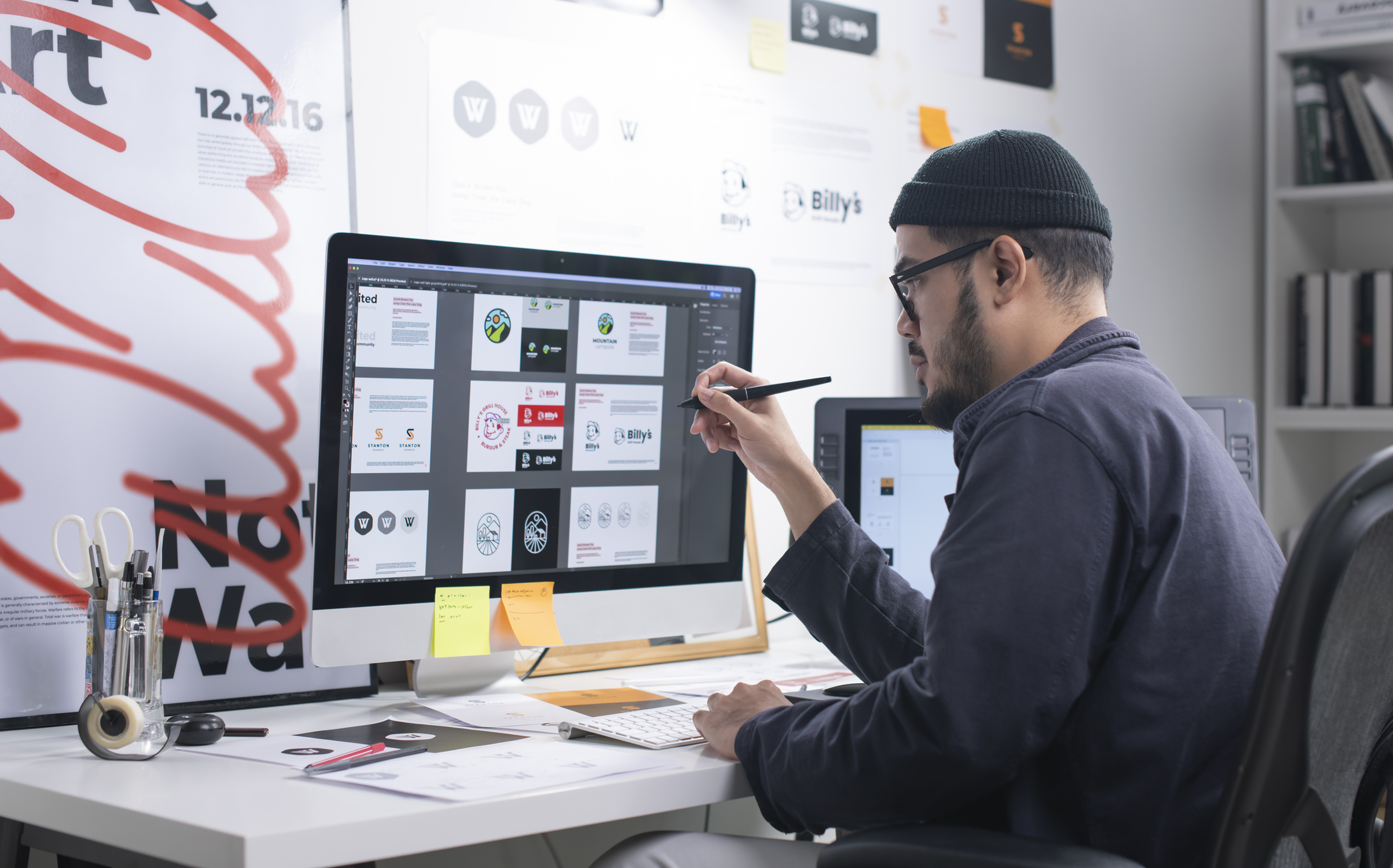 designer working at desk looking at Onward Search design jobs